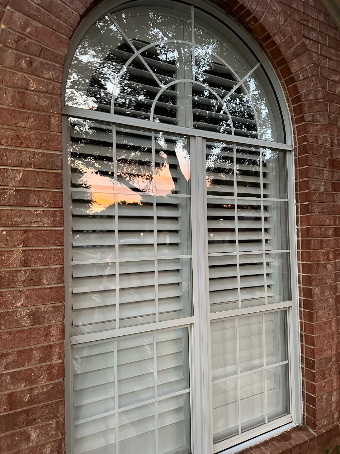 Arched window reflecting Austin sunset