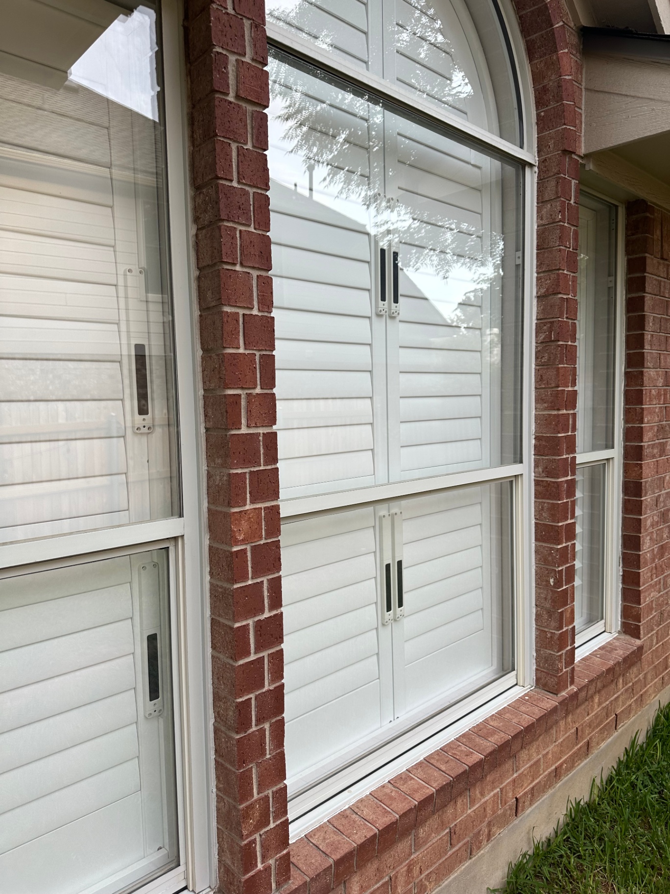 Large arched window on brick facade after cleaning